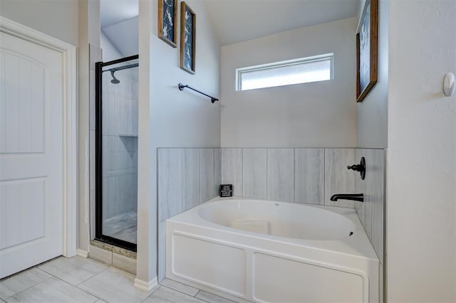 full bath with a bath and a stall shower