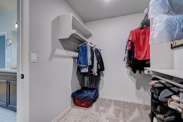 walk in closet with carpet