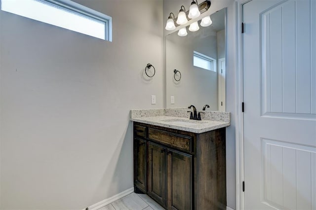 bathroom with vanity and baseboards