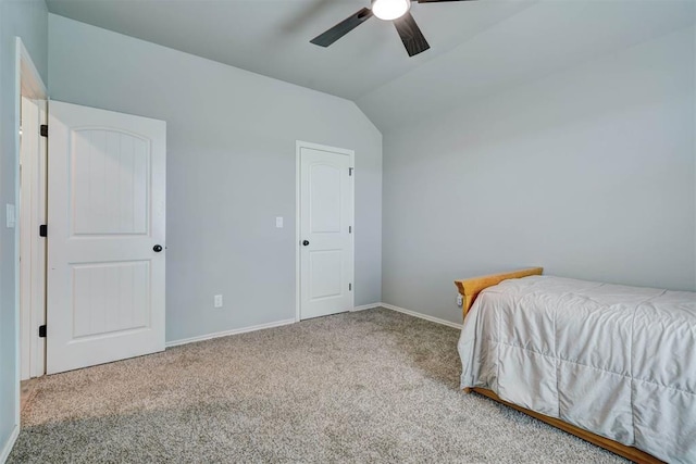 carpeted bedroom with baseboards, a ceiling fan, and vaulted ceiling