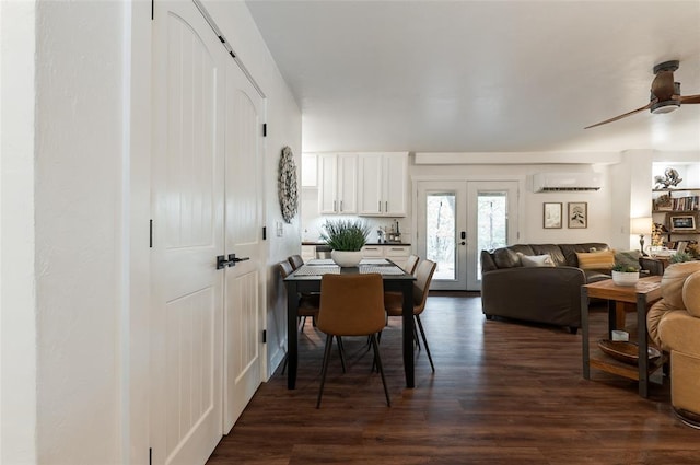 dining room featuring french doors, dark wood-style floors, a ceiling fan, and a wall unit AC