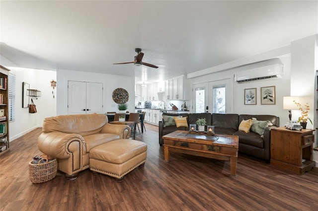 living area with ceiling fan, french doors, dark wood-style floors, and a wall mounted AC