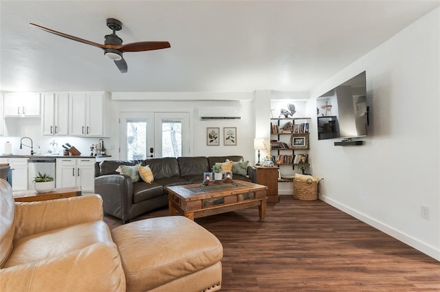 living area featuring a ceiling fan, baseboards, a wall mounted AC, dark wood-style flooring, and french doors