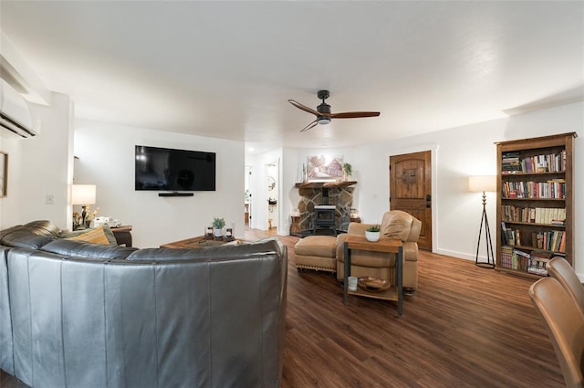 living room featuring baseboards, dark wood-style flooring, and ceiling fan