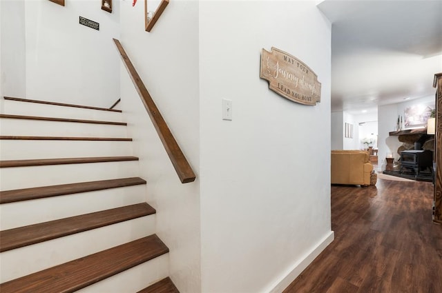 stairway with baseboards and wood finished floors