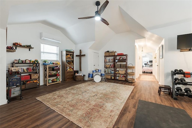 interior space with a wall mounted air conditioner, wood finished floors, a ceiling fan, and vaulted ceiling