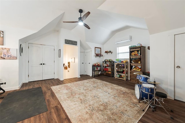 interior space with a wall mounted air conditioner, lofted ceiling, wood finished floors, baseboards, and ceiling fan