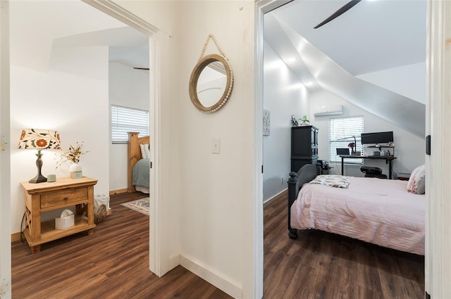 bedroom featuring baseboards, dark wood-style floors, and vaulted ceiling