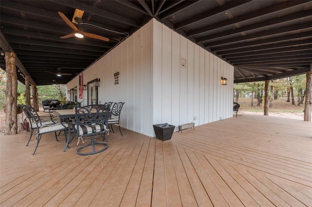 deck with outdoor dining space and ceiling fan