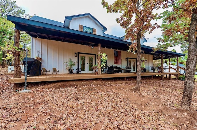 rear view of house featuring french doors, board and batten siding, and a deck