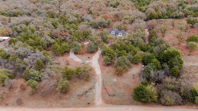 drone / aerial view featuring a view of trees