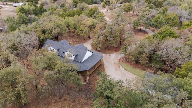 birds eye view of property with a view of trees