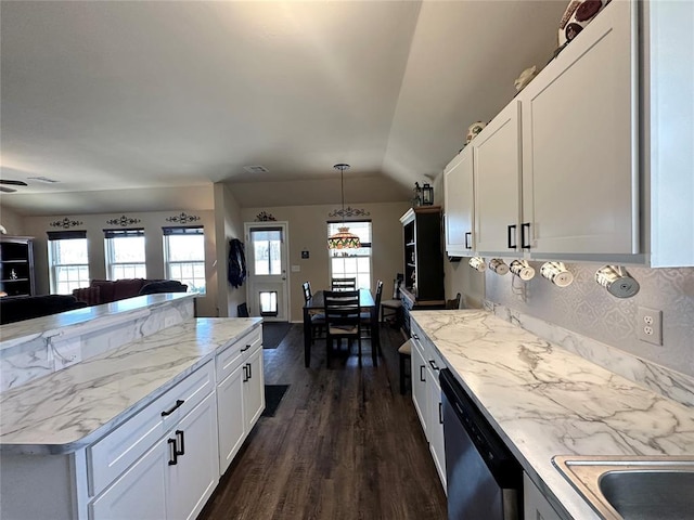 kitchen featuring plenty of natural light, white cabinets, open floor plan, and stainless steel dishwasher