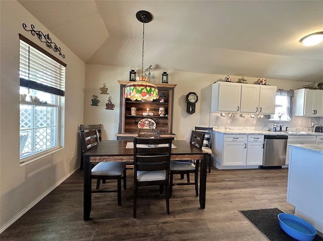 dining area with baseboards, dark wood-type flooring, and vaulted ceiling