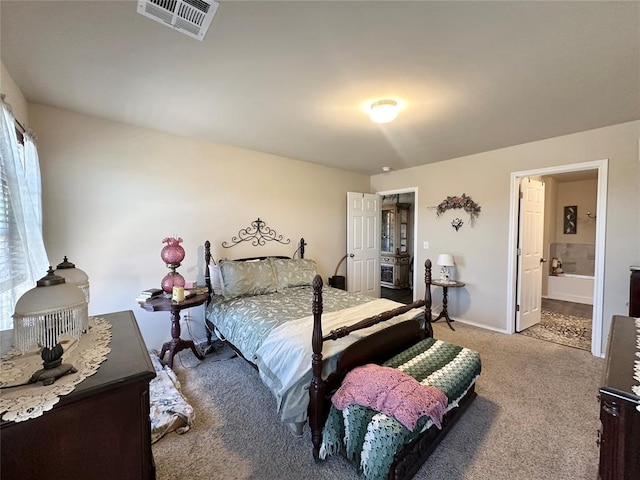 bedroom featuring ensuite bathroom, baseboards, visible vents, and carpet floors