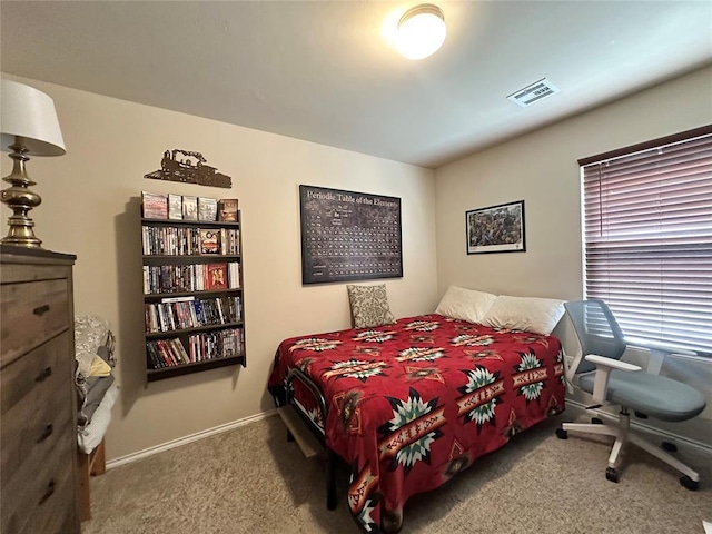 carpeted bedroom with visible vents and baseboards