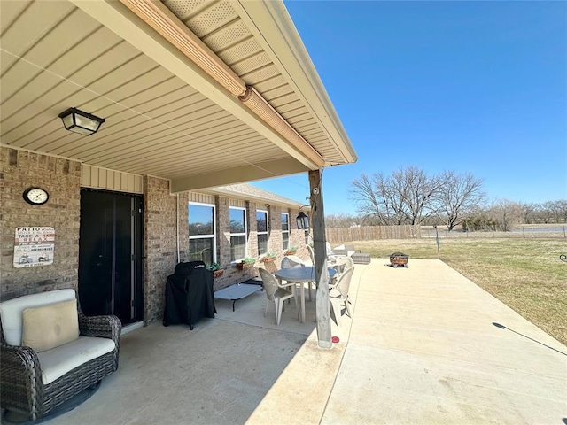 view of patio featuring a fire pit, fence, and a grill