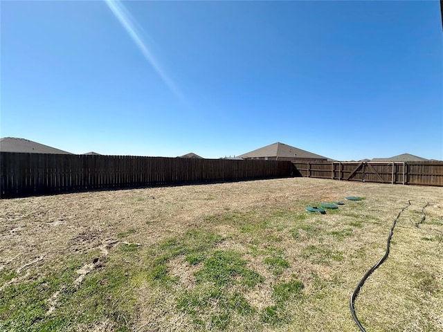 view of yard with a fenced backyard