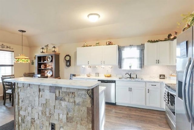 42195 Elles Way, Shawnee, OK 74804 - kitchen with stainless steel appliances, light countertops, white cabinetry, wood finished floors, and vaulted ceiling