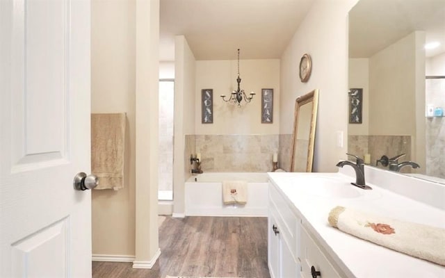 42195 Elles Way, Shawnee, OK 74804 - bathroom featuring a bath, wood finished floors, a chandelier, and vanity