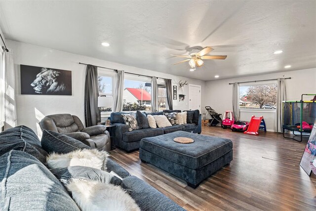 living room with recessed lighting, dark wood-style flooring, and ceiling fan