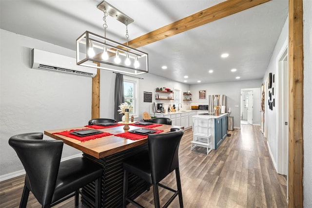 dining room featuring beam ceiling, wood finished floors, a wall unit AC, recessed lighting, and baseboards