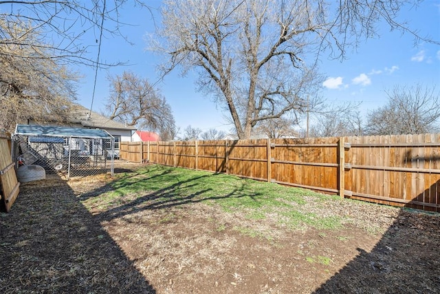 view of yard featuring an outbuilding and a fenced backyard