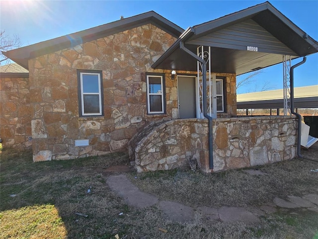 view of front of house featuring stone siding and crawl space