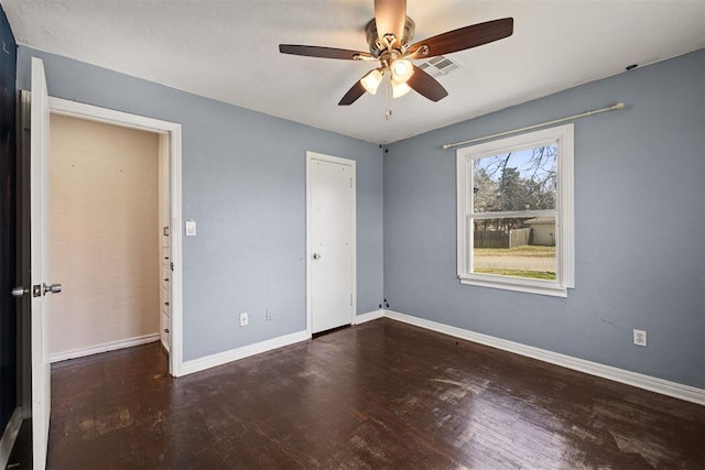 unfurnished bedroom with visible vents, ceiling fan, baseboards, and wood finished floors