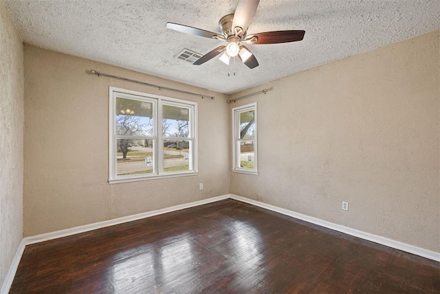 spare room with visible vents, baseboards, ceiling fan, and wood finished floors