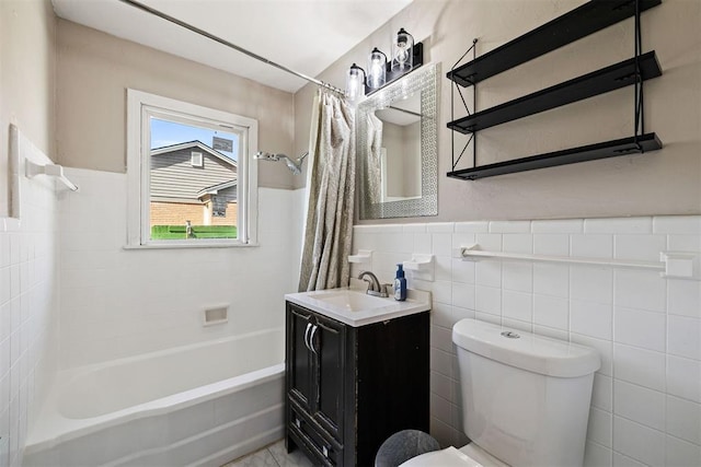 full bathroom featuring vanity, shower / bathtub combination with curtain, wainscoting, tile walls, and toilet