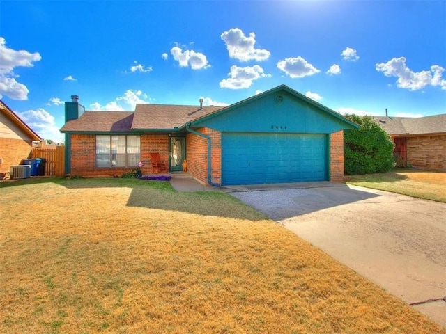 ranch-style home featuring brick siding, cooling unit, an attached garage, and a front yard