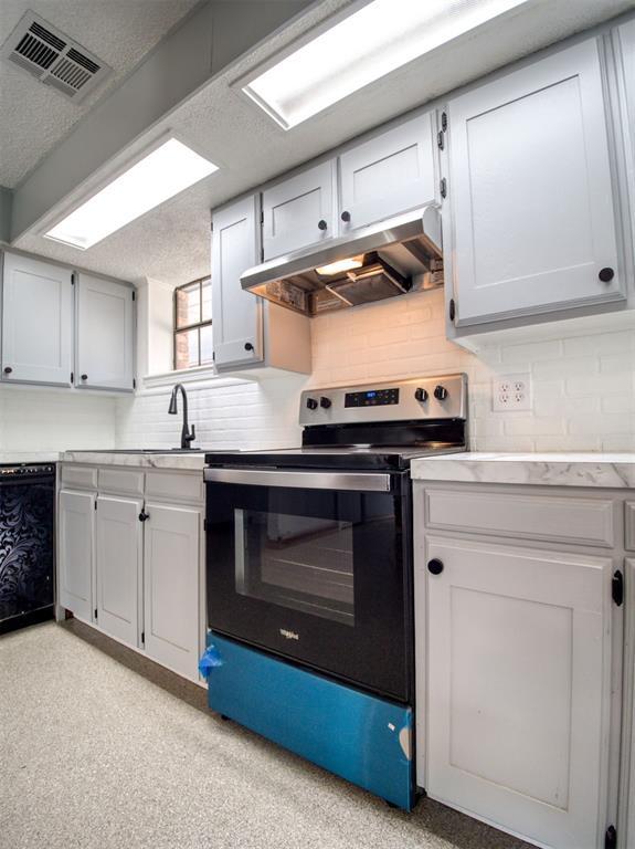 kitchen with visible vents, range with electric cooktop, under cabinet range hood, dishwasher, and light countertops