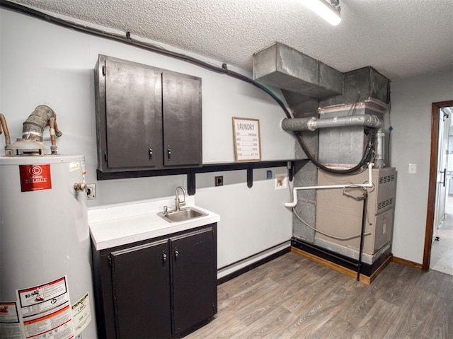 utilities with heating unit, gas water heater, and a sink