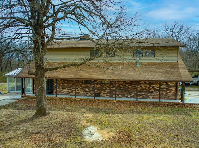 rear view of house with brick siding