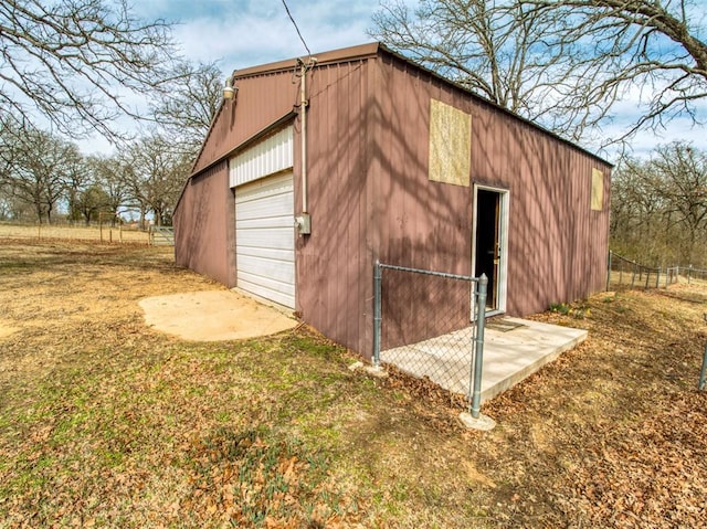 view of outdoor structure with an outbuilding and fence