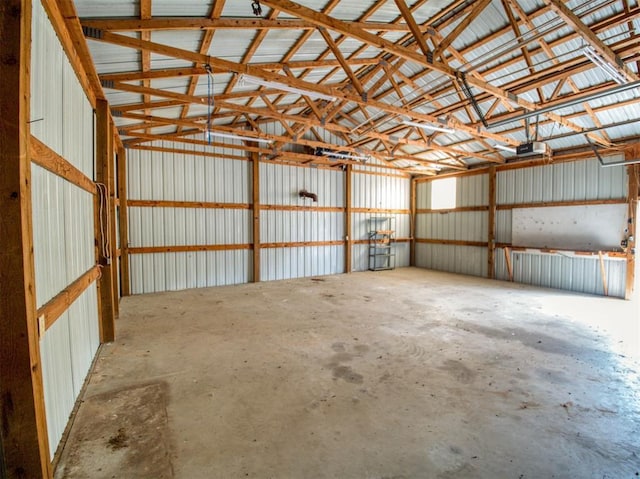 garage with metal wall and a garage door opener