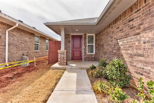 doorway to property with brick siding