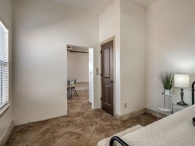 bedroom with stone finish floor and baseboards