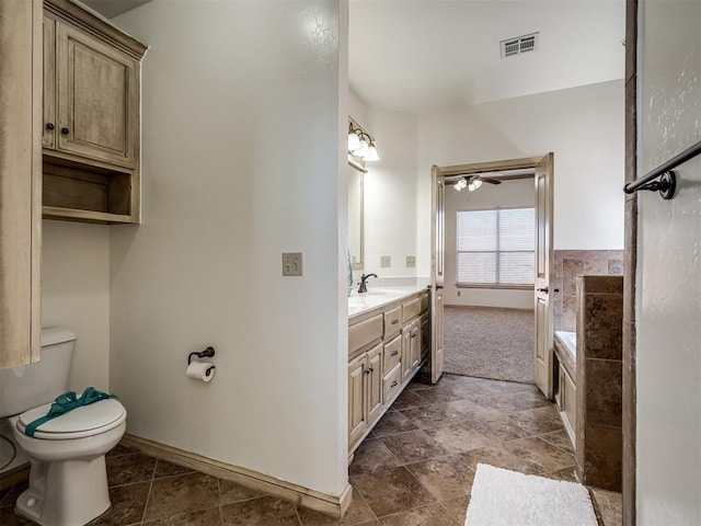 full bath with vanity, baseboards, visible vents, a bathing tub, and toilet