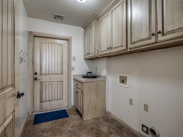 washroom with hookup for a washing machine, visible vents, hookup for an electric dryer, baseboards, and cabinet space