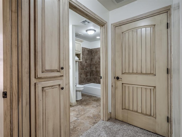 full bathroom with visible vents and toilet