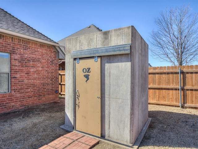 view of shed featuring fence