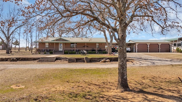 view of front of home with driveway and metal roof