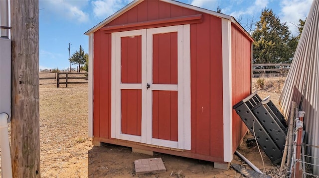 view of shed with fence