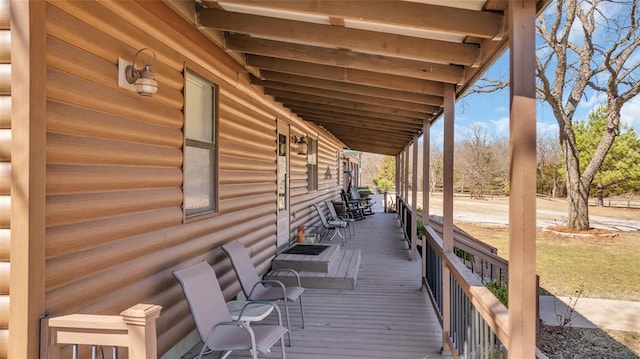 wooden terrace featuring covered porch