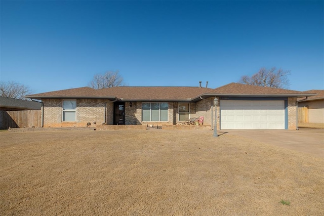 ranch-style house with brick siding, concrete driveway, an attached garage, and fence