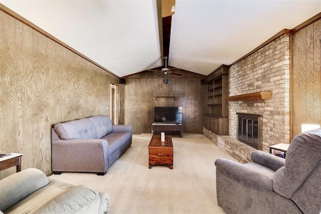 carpeted living area featuring wooden walls, built in shelves, lofted ceiling with beams, ceiling fan, and a brick fireplace