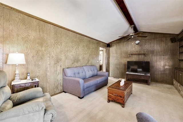 carpeted living area with lofted ceiling with beams and ceiling fan