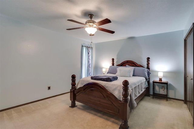 bedroom with light carpet, a ceiling fan, and baseboards